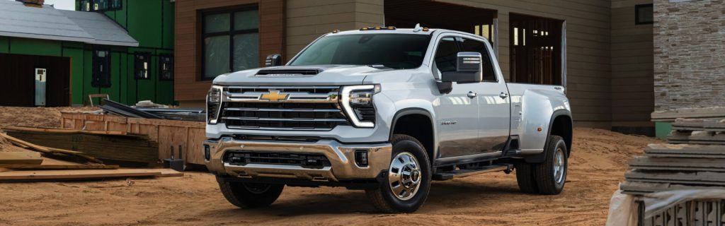 A white 2025 Silverado 3500 HD parked at a home construction site near Turner Chevrolet, showcasing its heavy-duty capability and rugged design.




