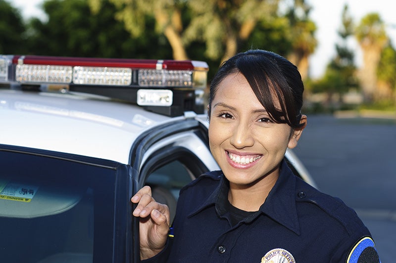 Woman Police Officer Standing Near Police Van